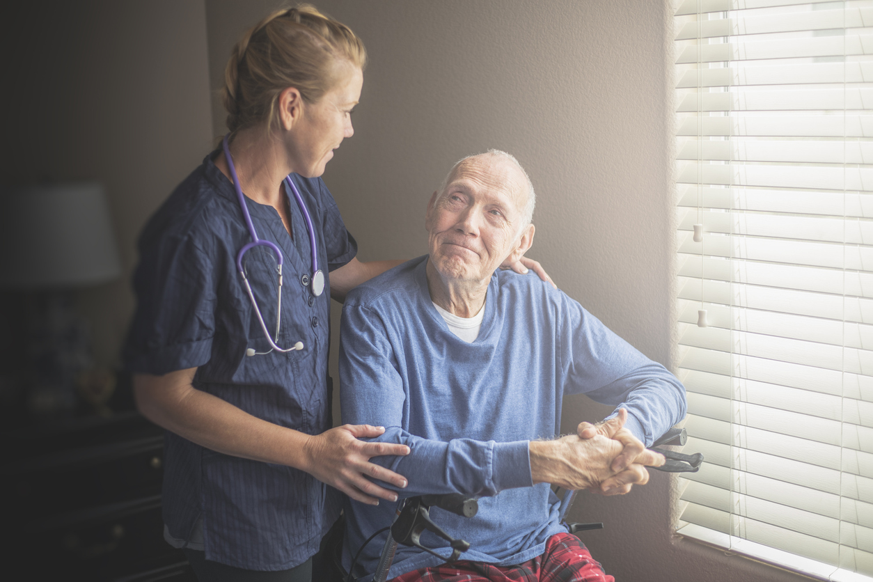 Hospice team member holding a patient while offering comfort and guidance